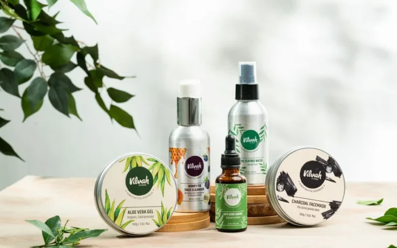 Close-up of natural skincare products including aloe vera gel and charcoal face mask.