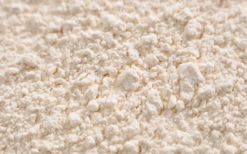 Detailed close-up of a white powder texture, resembling flour or sugar.
