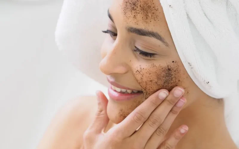 Woman enjoying skincare routine with coffee scrub exfoliation for healthy skin.