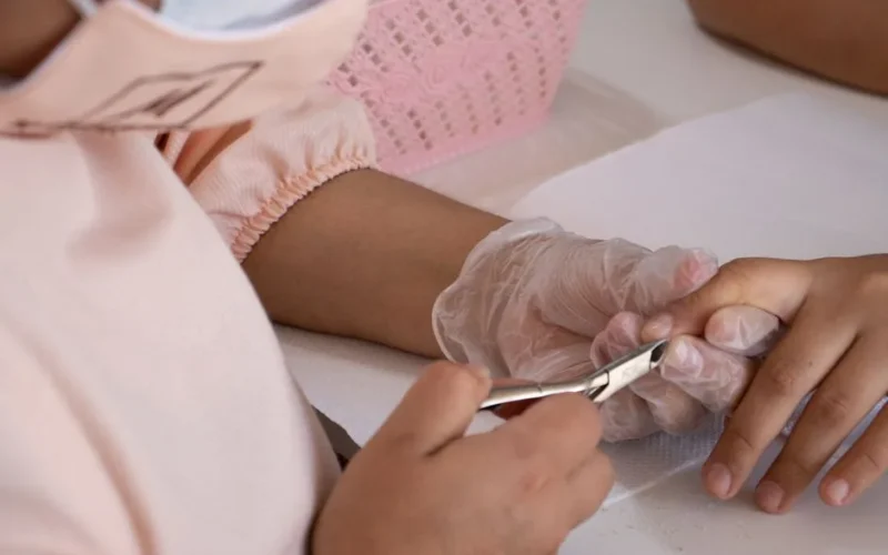 Close-up of a professional manicure session focusing on nail care and hygiene.