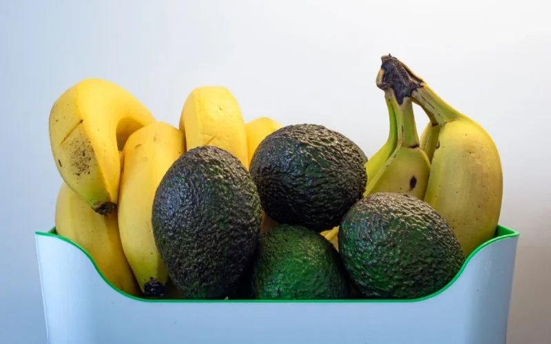 A close-up of ripe avocados and bananas arranged in a basket, perfect for healthy eating.