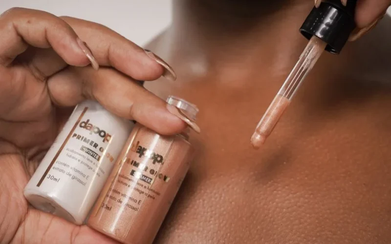 A detailed view of primer being applied to skin with a dropper.