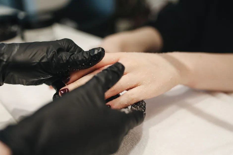 Close-up of a hand receiving a luxurious spa treatment with exfoliating scrub in a beauty salon.
